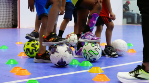 Kids feet playing with soccer balls